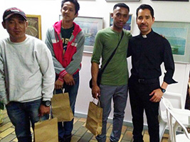 Fr Pablo Velasques with seafarers and their Christmas gift bags