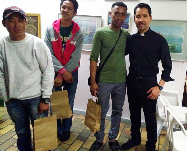 Fr Pablo with seafarers and their Christmas gift bags